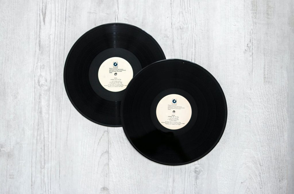 photography of vinyl records on wooden surace