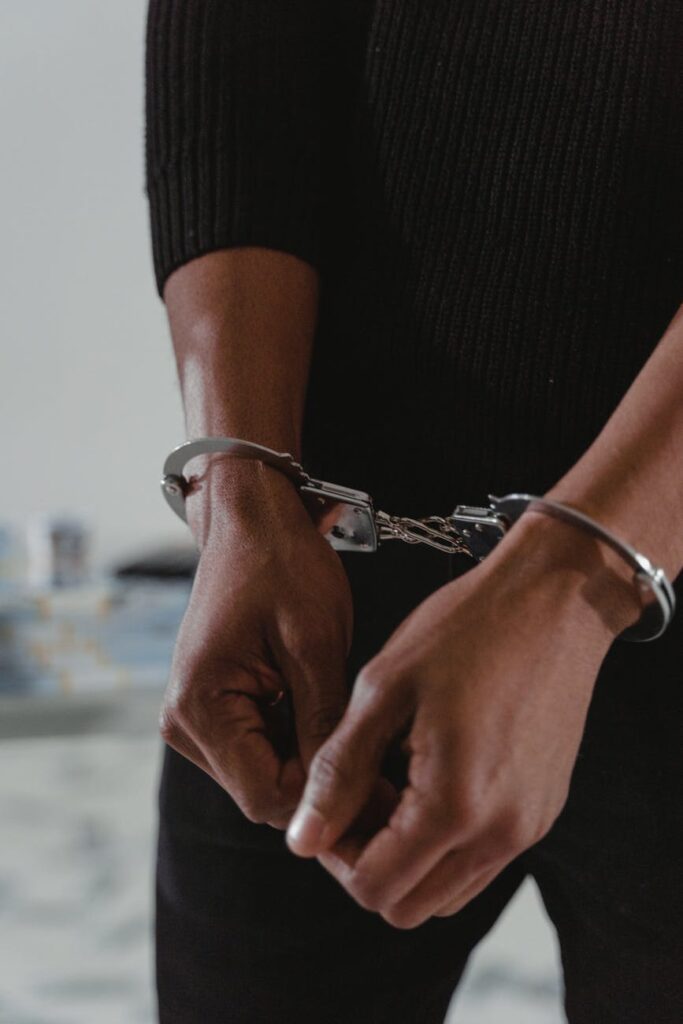 persons hands in handcuffs
